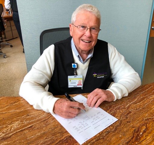 man at desk smiling