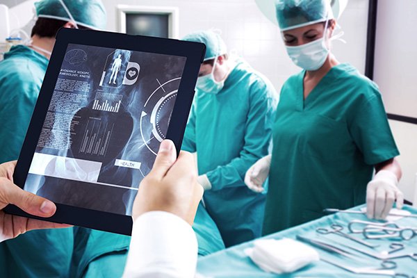 Doctor using tablet against medical interface on xray 