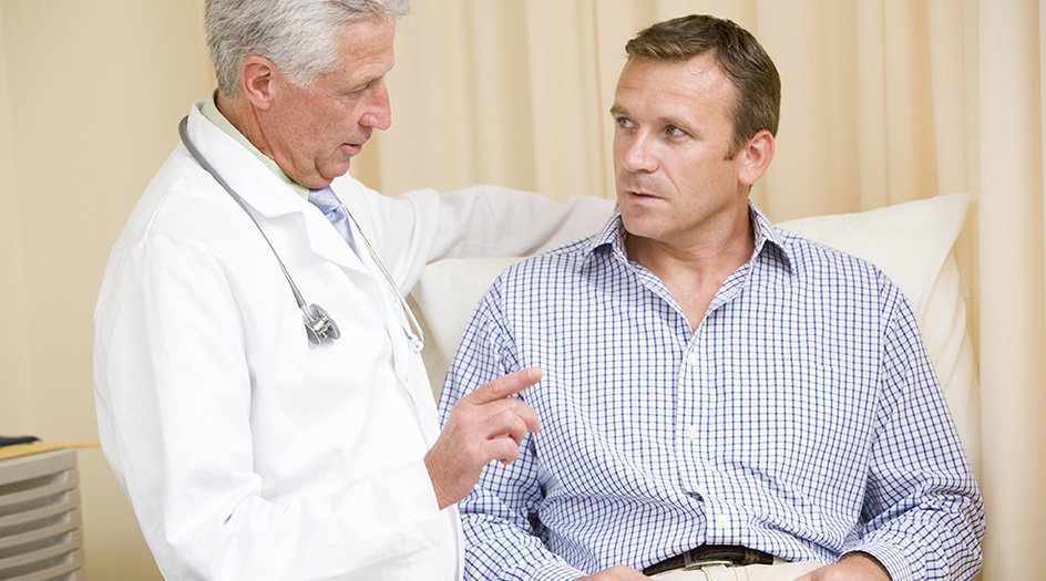 Doctor talking to male patient