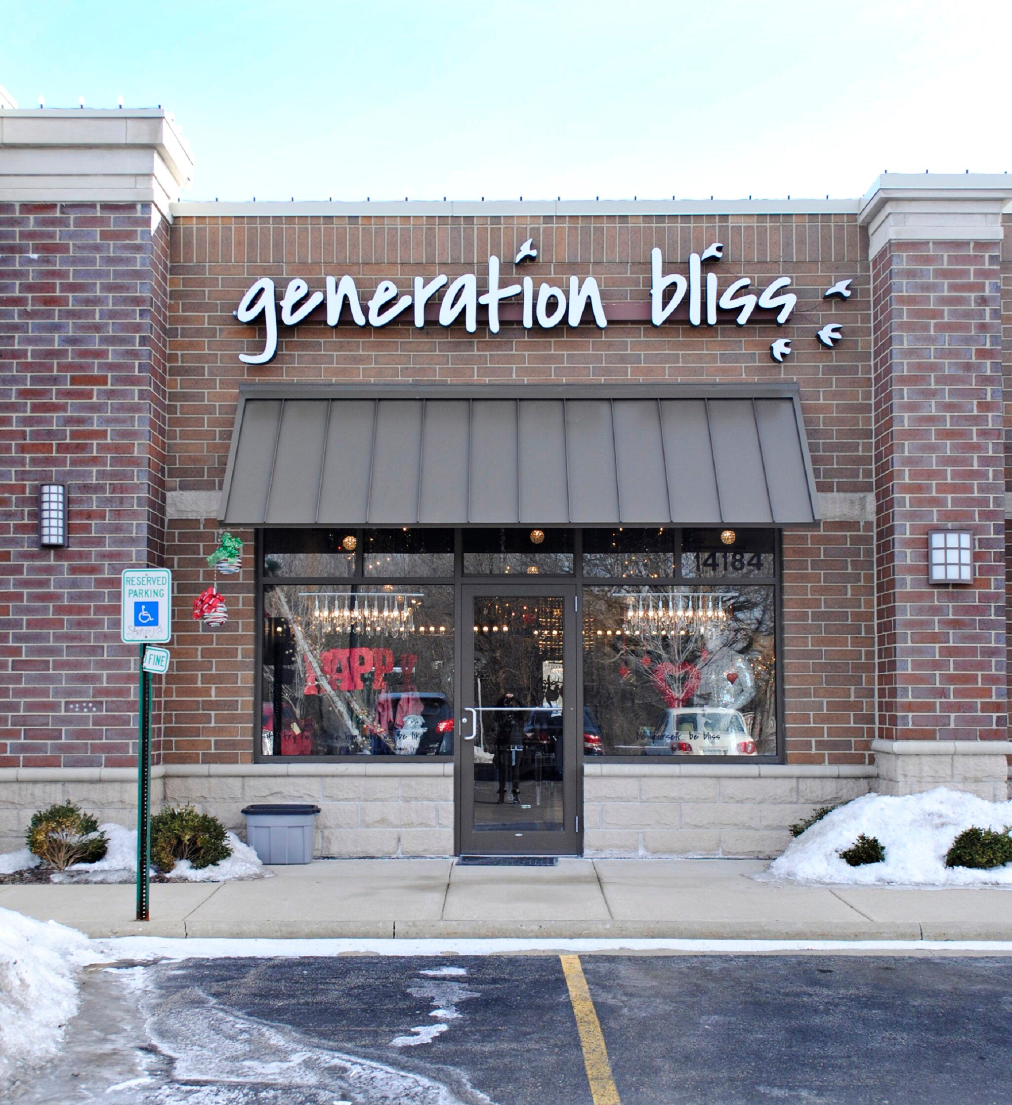 Generation Bliss Storefront, Red Brick with Brown Awning above Glass Store front